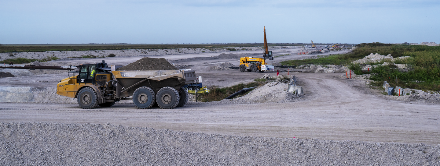 Yellow construction truck on a dirt road