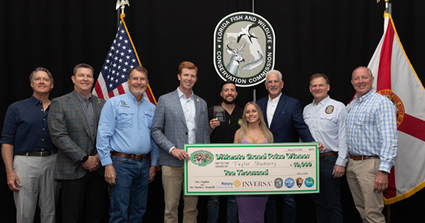 Python Challenge Winner holding a big check